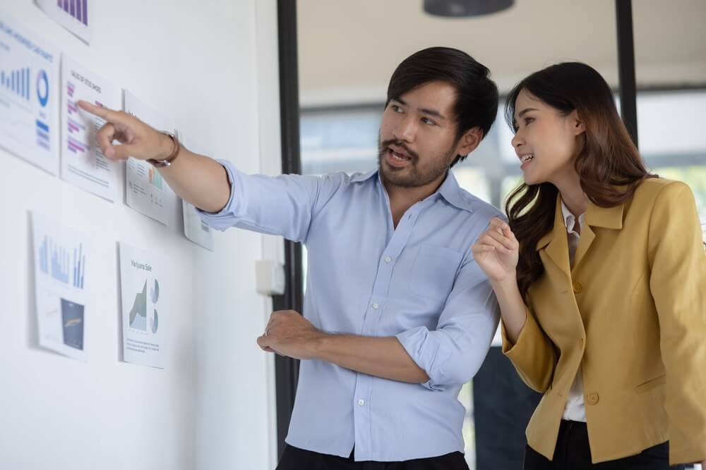 2-people-looking-at-wall-charts