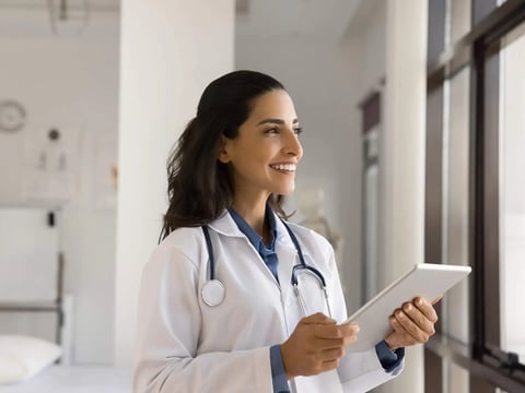Female doctor smiling holding clipboard