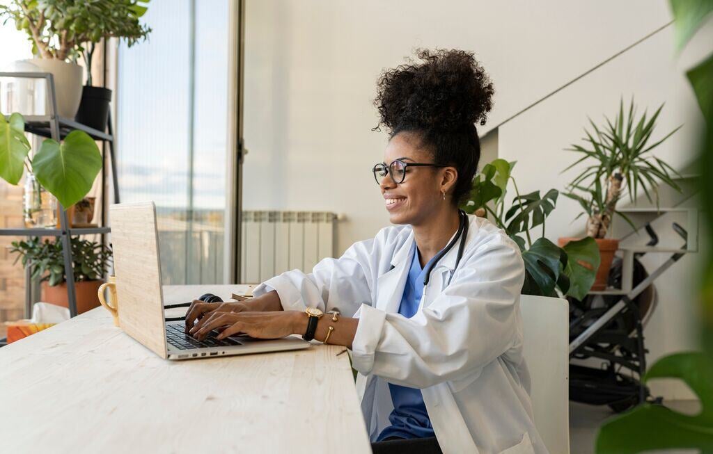 Doctor using laptop at home office