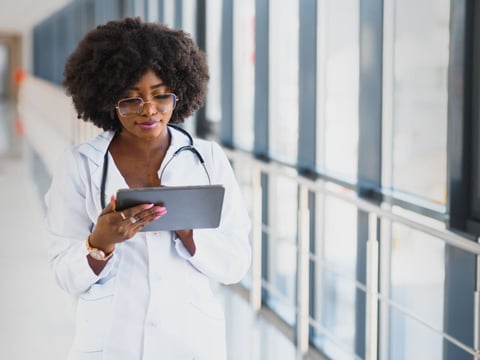 Female doctor using tablet