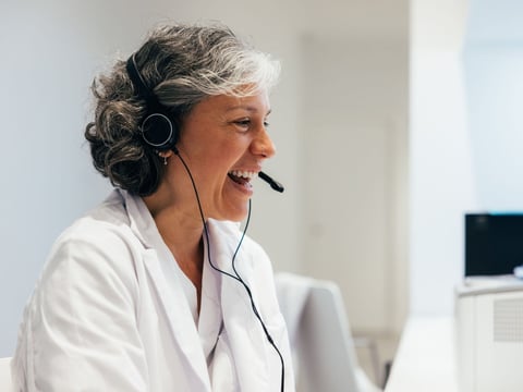 Woman in medical uniform working on computer