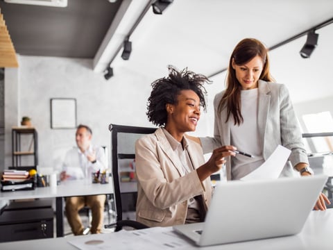 Woman showing something to another colleague