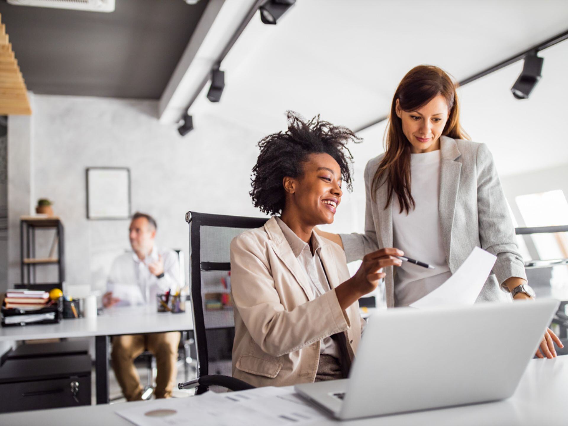 Woman showing something to another colleague