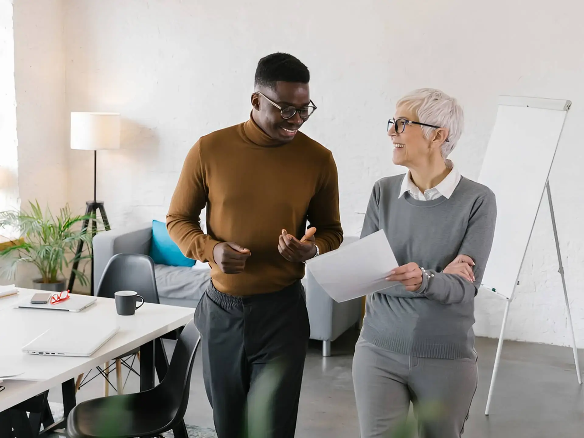 Colleagues walking and talking with documents
